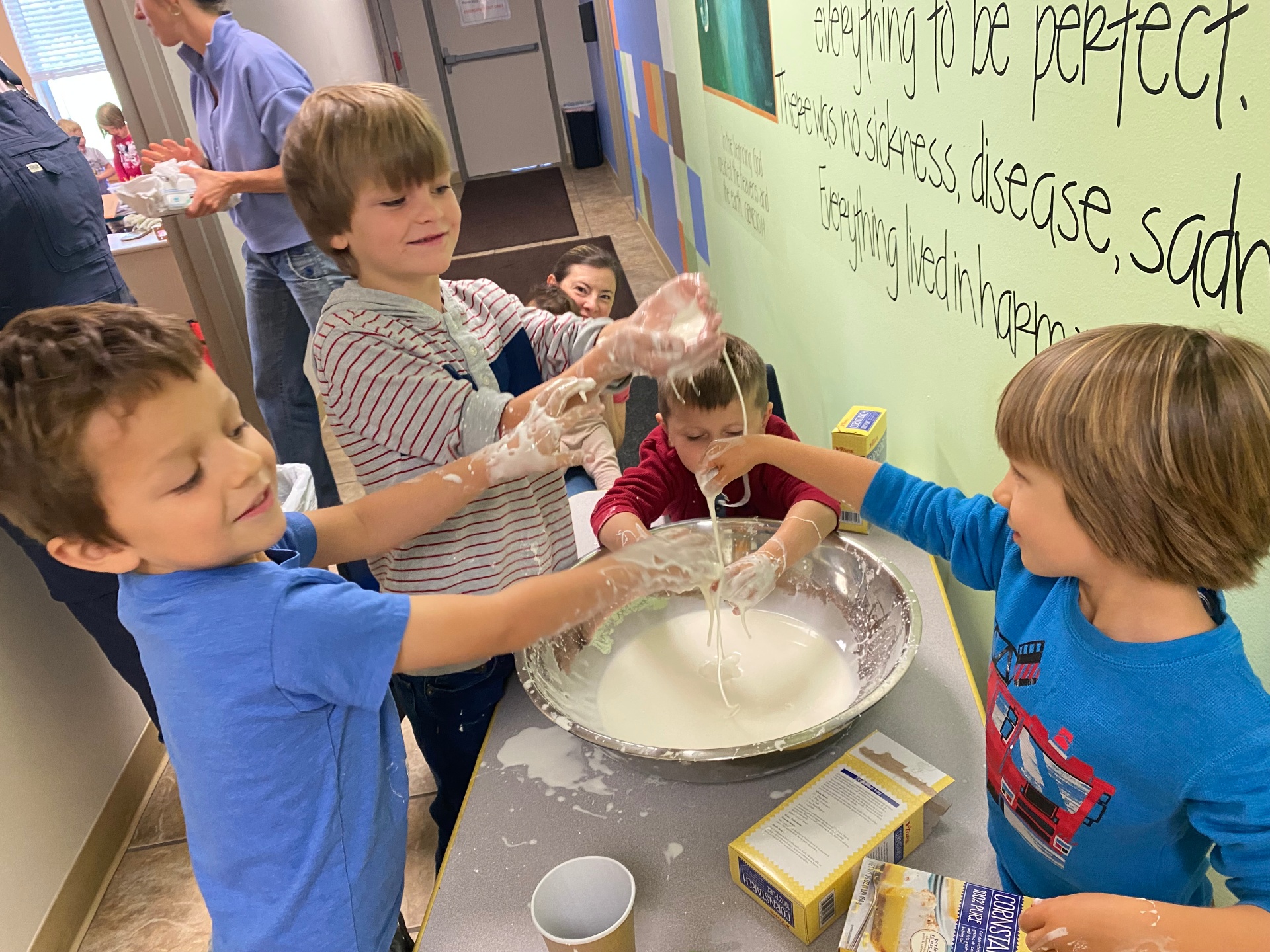 Kids joyfully experimenting with cornstarch and water