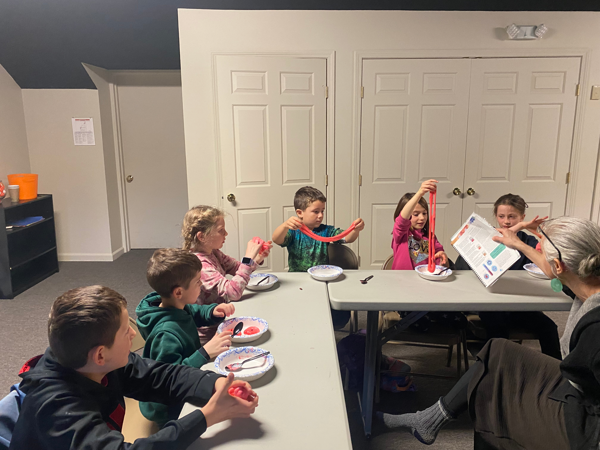 Children making slime together at a co-op table