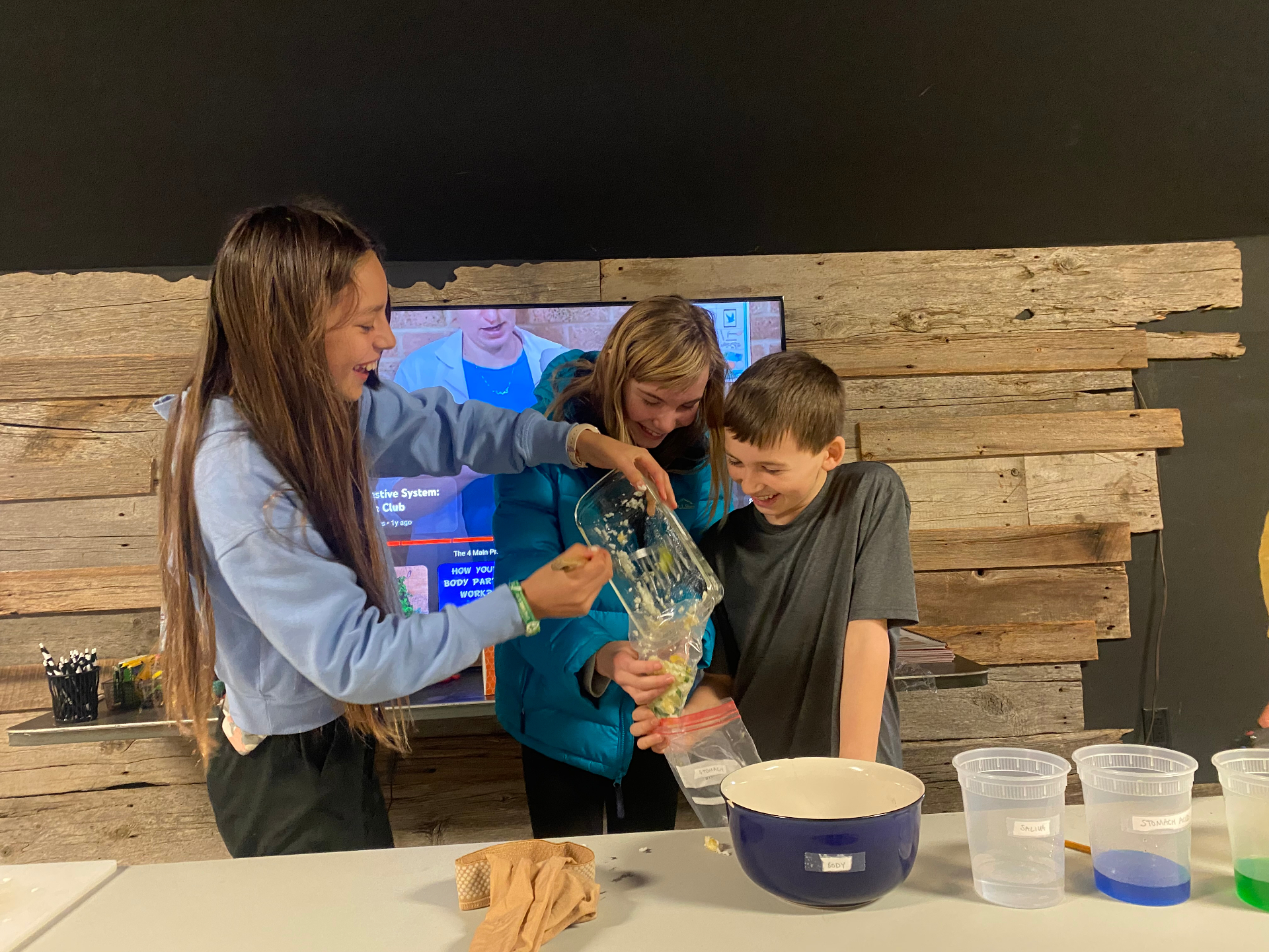 Kids laughing through a digestive system science experiment